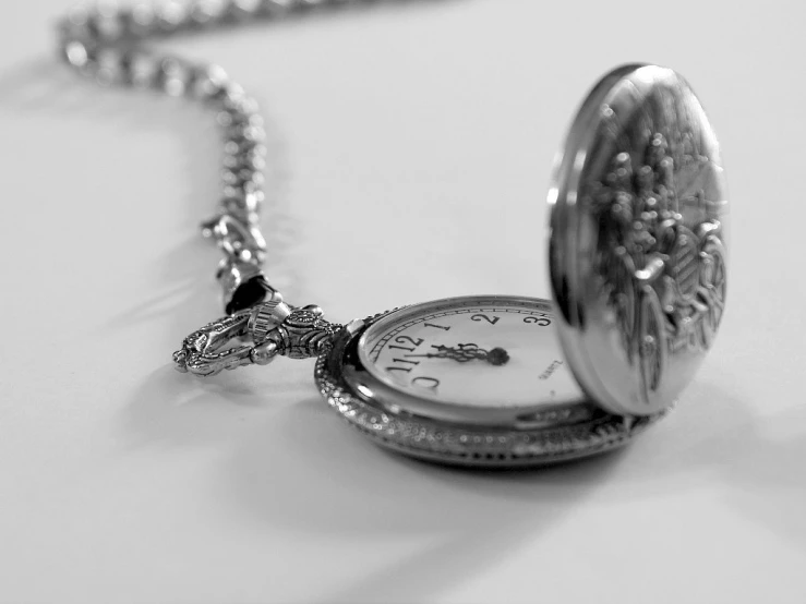 a close - up of a pocket watch laying on the table