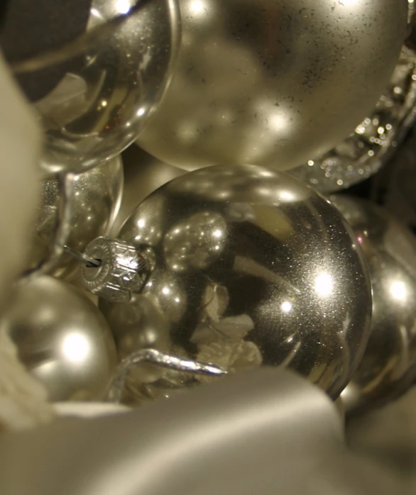 silver ornaments sit in the corner of a plate