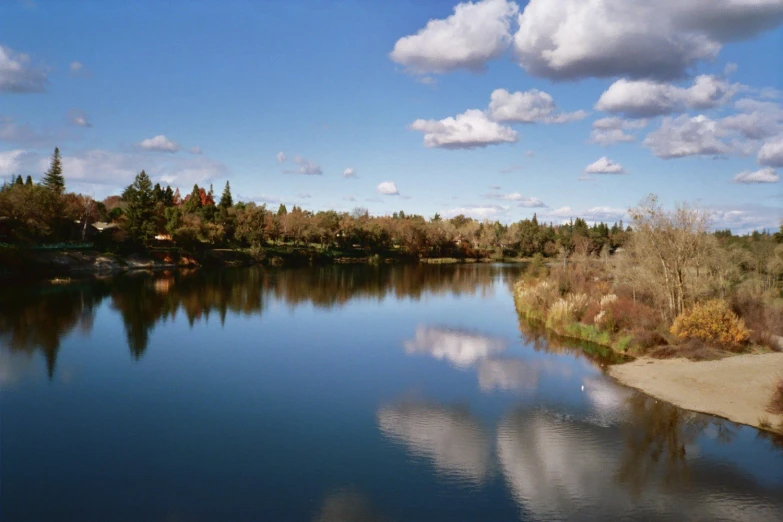 a scenic lake with clouds in the sky