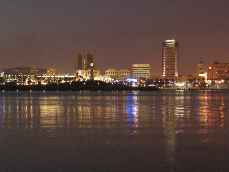 some buildings are next to a river and buildings on the other side