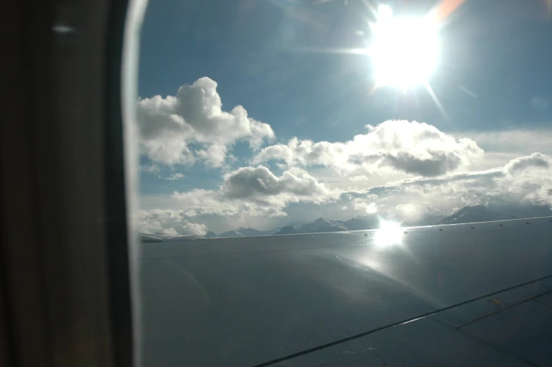 the wing of an airplane flying through the clouds