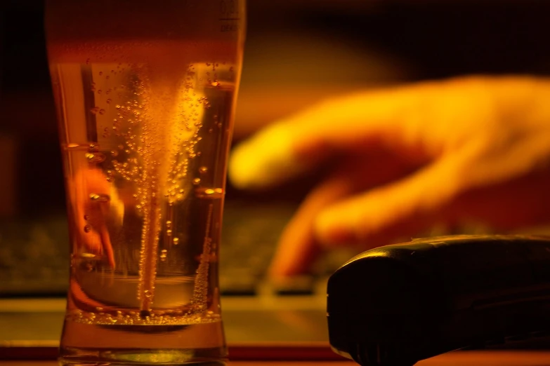 a glass filled with liquid on top of a counter