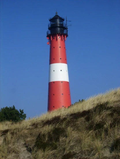 the light house on top of a hill overlooking a field