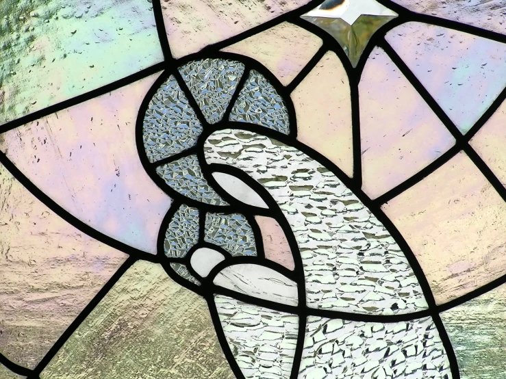 a stained glass window of an abstract design with a large white bird