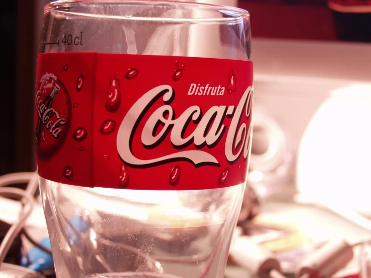 this glass is full of a soda can sitting on the counter