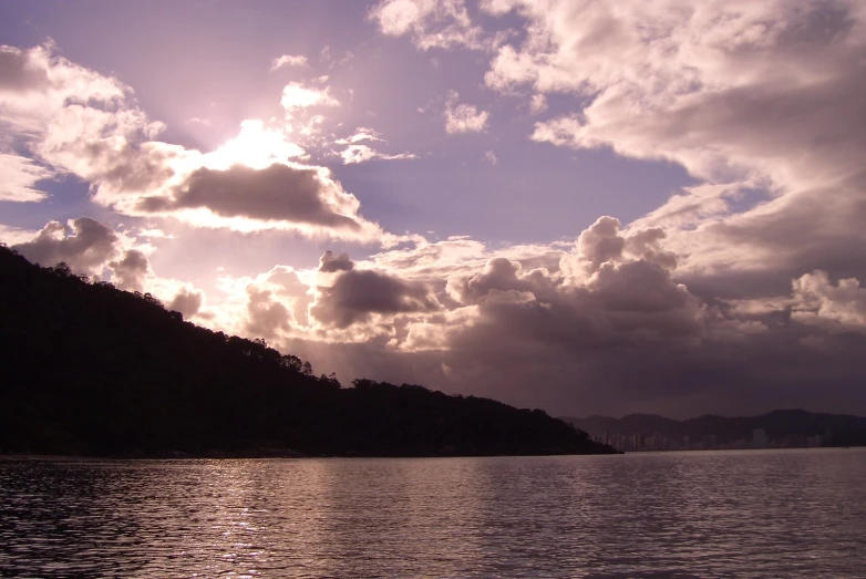 a view of a lake with trees and sky