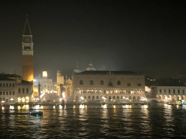 a picture of a city by the water at night