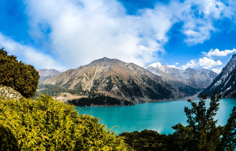 a large blue body of water surrounded by mountains