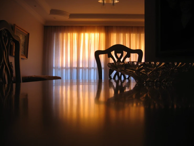 an empty chair is placed in front of a window