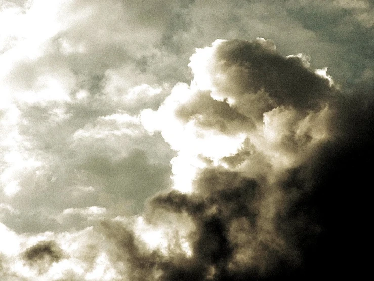 clouds are billowing in the sky above a building