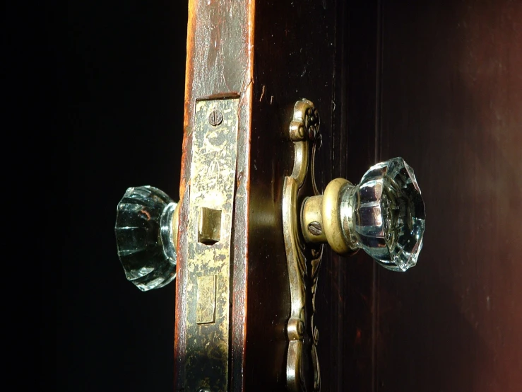 an old, weathered wood and ss door handle