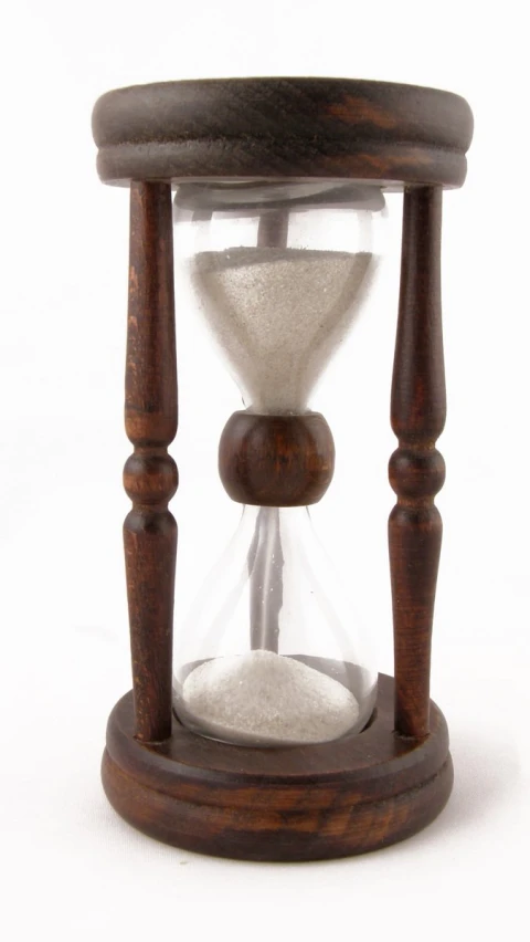 the old wooden clock has white sand under it