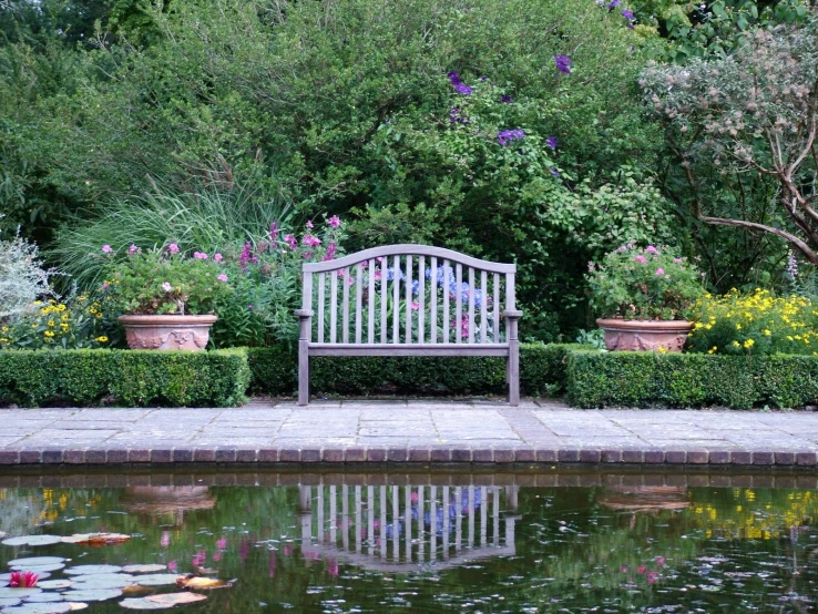 a bench is sitting in the middle of a pond