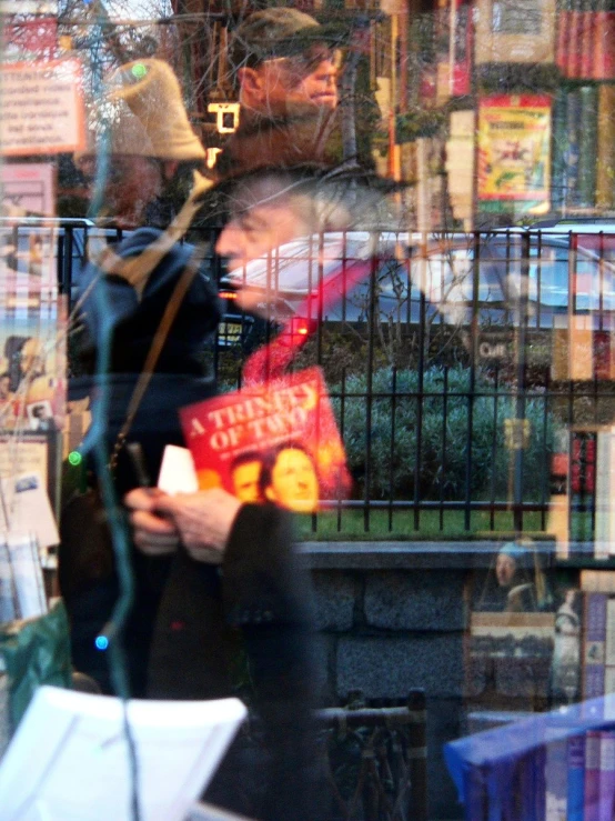 two people stand by a liry with their books