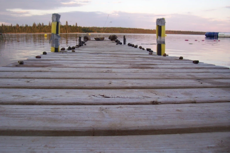 the pier is made of wood and has a yellow gate