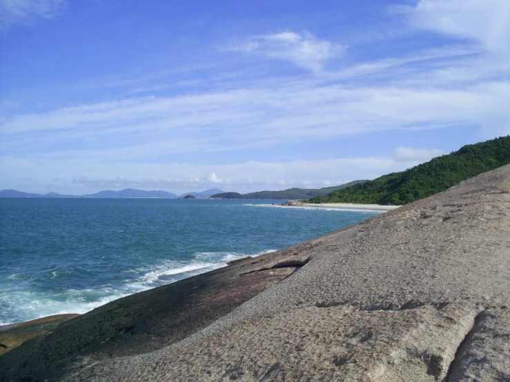 a man looking out at the ocean from an overlook