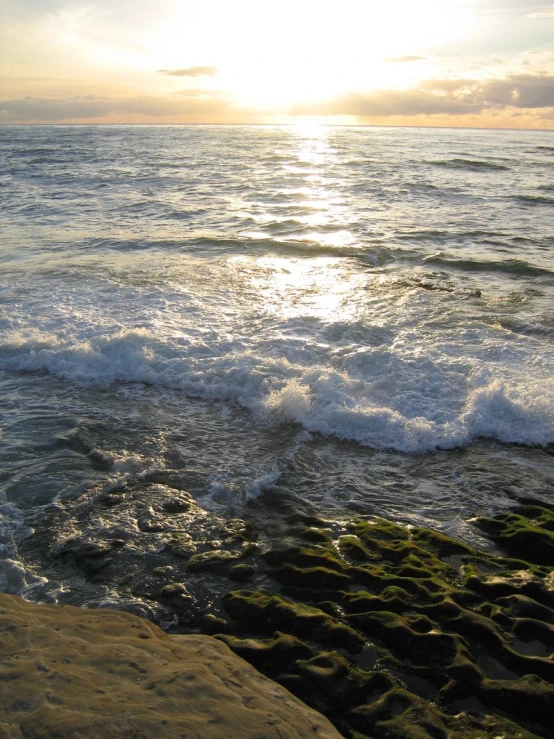 an ocean beach with waves crashing in the water