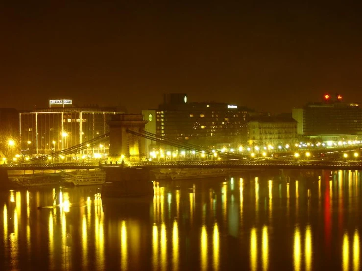 there are buildings along the water on this very busy river