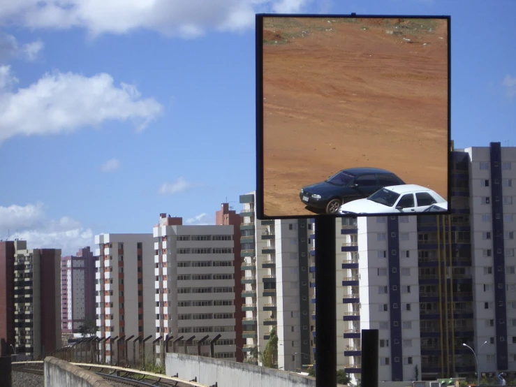 an advertit featuring a silver car on a billboard