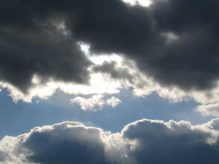 a blue sky with clouds and airplanes flying in the sky