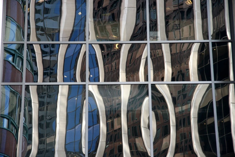 the glass walls and reflection of many skyscrs