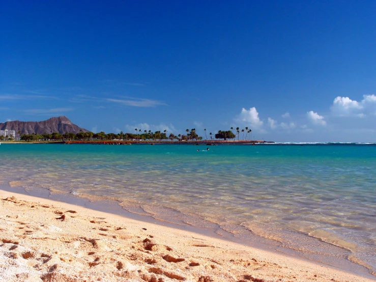 a beach with several boats in the water