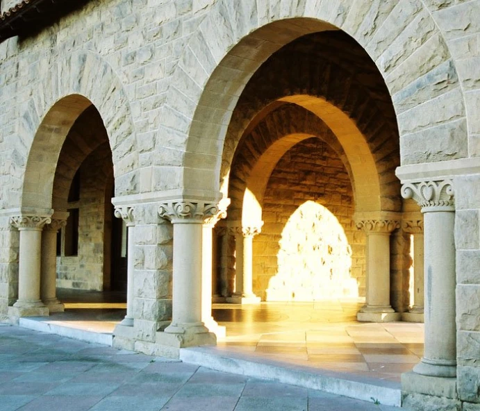 a room with arches that have light coming out of them
