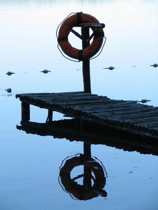 a dock that has a life preserver sitting on top of it