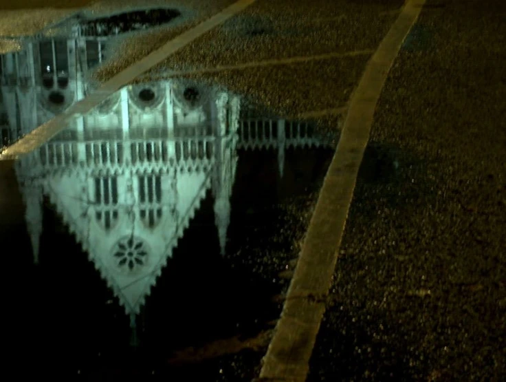 a clock tower is sitting behind the pavement