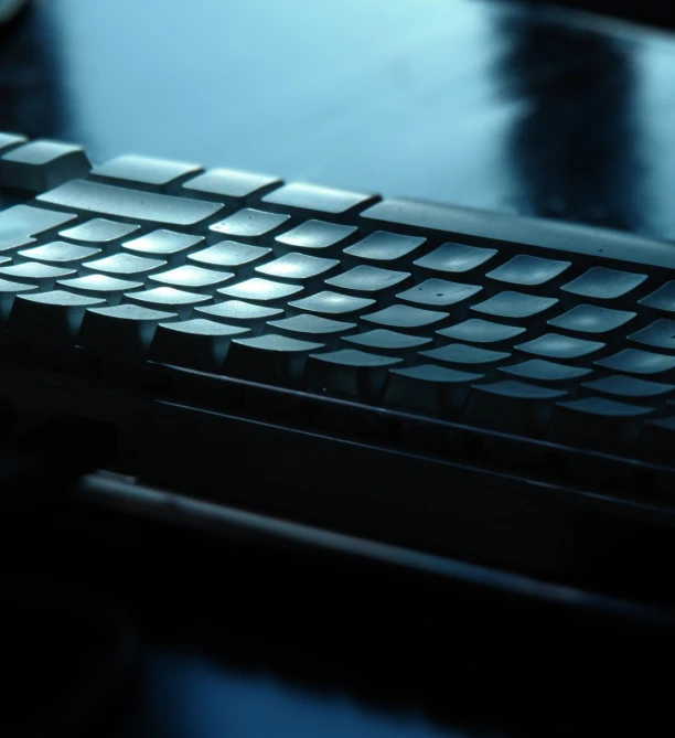 a computer keyboard is shown lit up in the dark