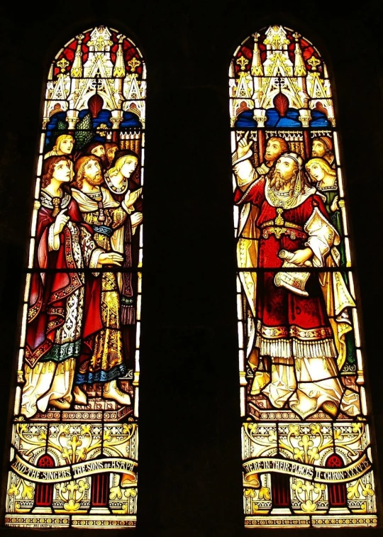 two stain glass windows showing the image of saint mary