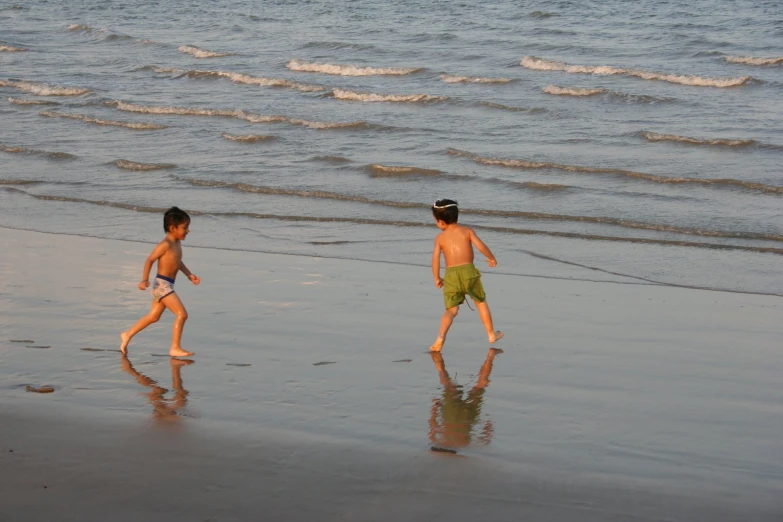 a boy and girl are on the beach