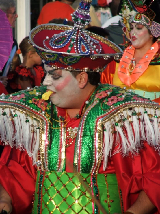 a couple of people wearing carnival makeup and masks