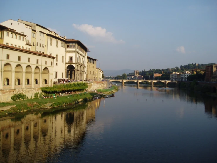 a bridge in the distance with a body of water next to it