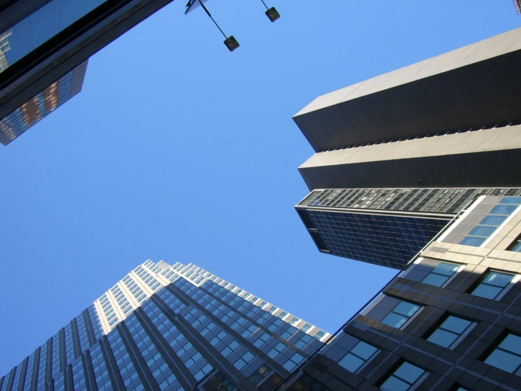 a couple of tall buildings with a clear sky in the background