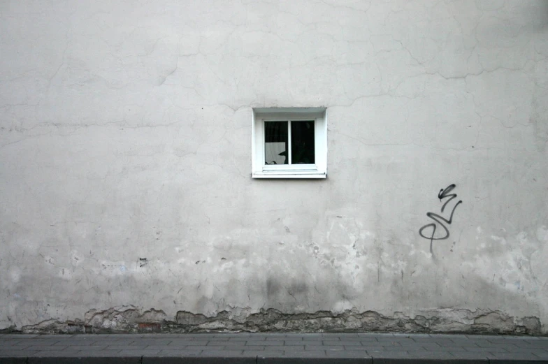 a concrete building with a window on the side