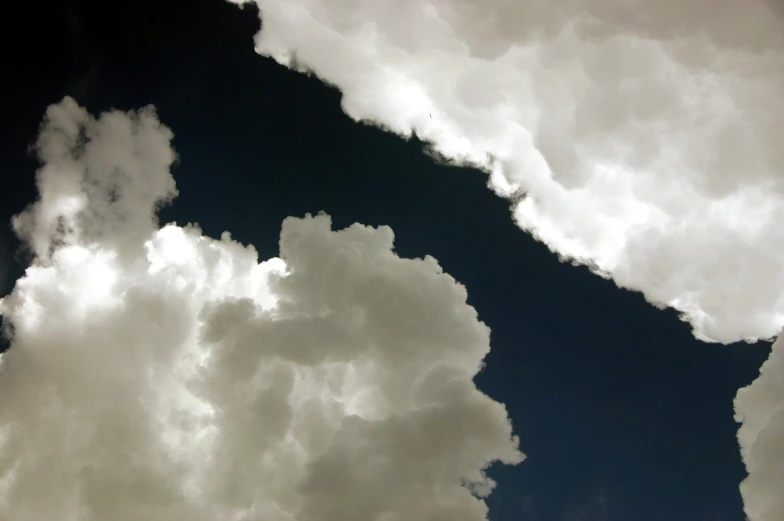 looking up at an airplane that is flying through the air