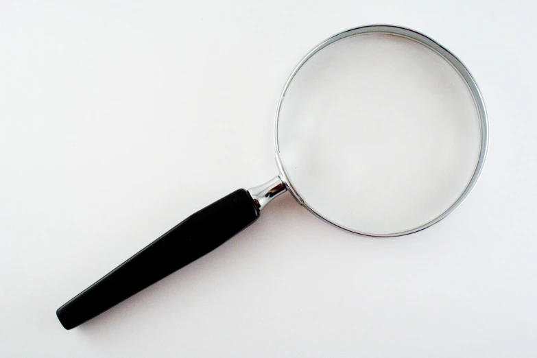 magnifying glass on white background with focus on the handle