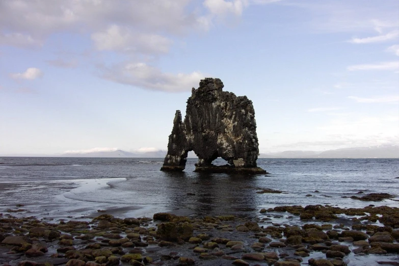 two rocks that are standing in the water