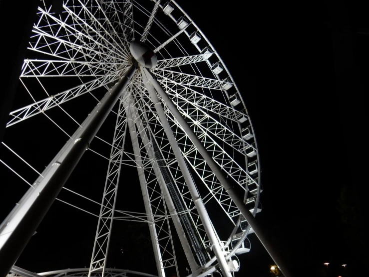 there is a large wheel at the park on a dark day