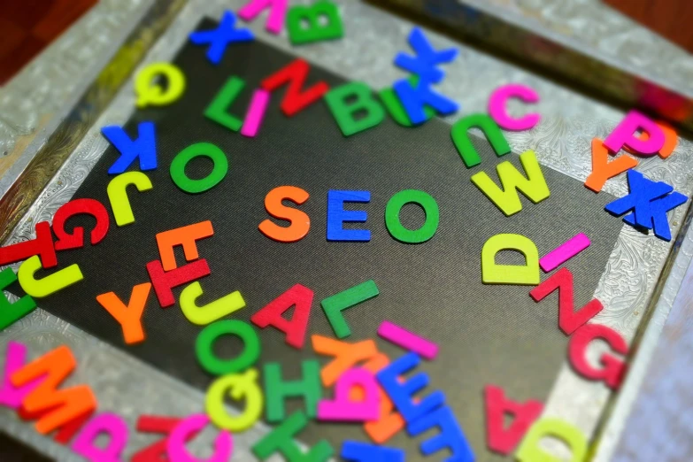 the letters of a magnetic board are spelled by colored wooden letters