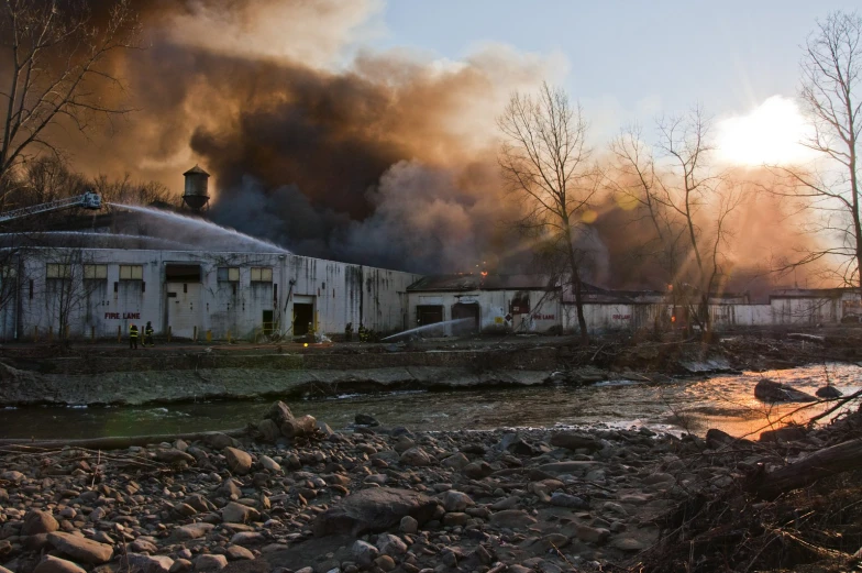 smoke coming from a large factory in the distance