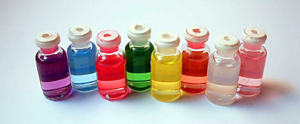 a row of bottles with different colored liquids in them