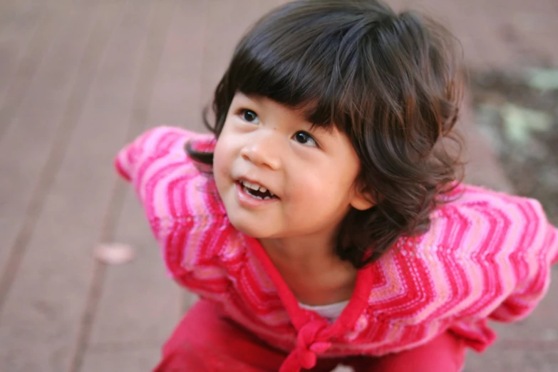 a close up of a child smiling at the camera