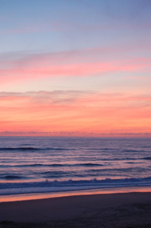 a blue and pink sunset at the beach