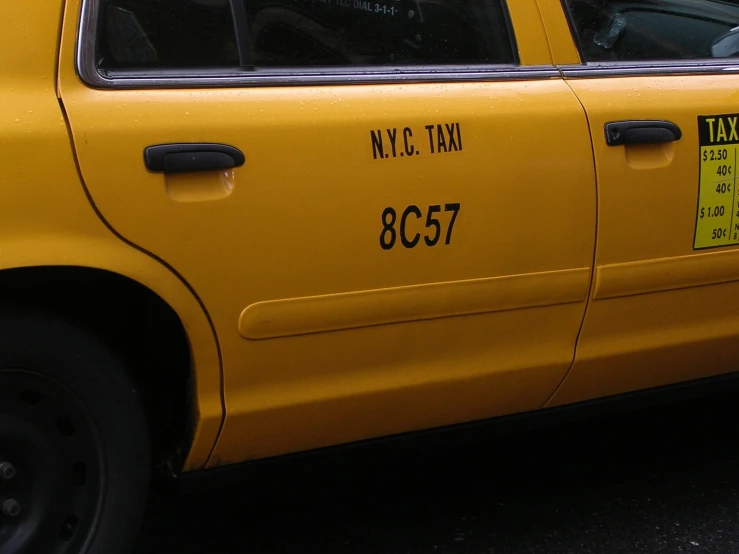 a yellow taxi cab is shown parked on the street
