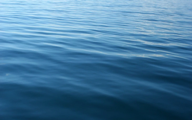 the water is very blue and the reflection is not as blue as the water itself