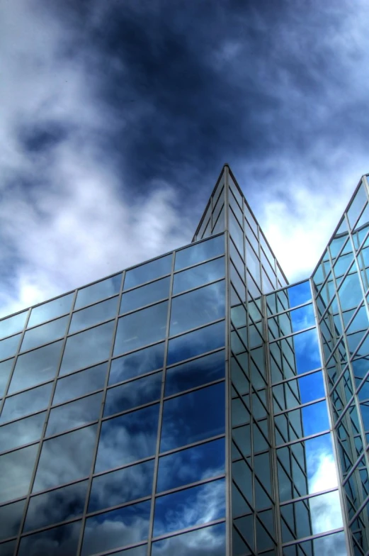 several tall buildings sitting under a cloudy sky