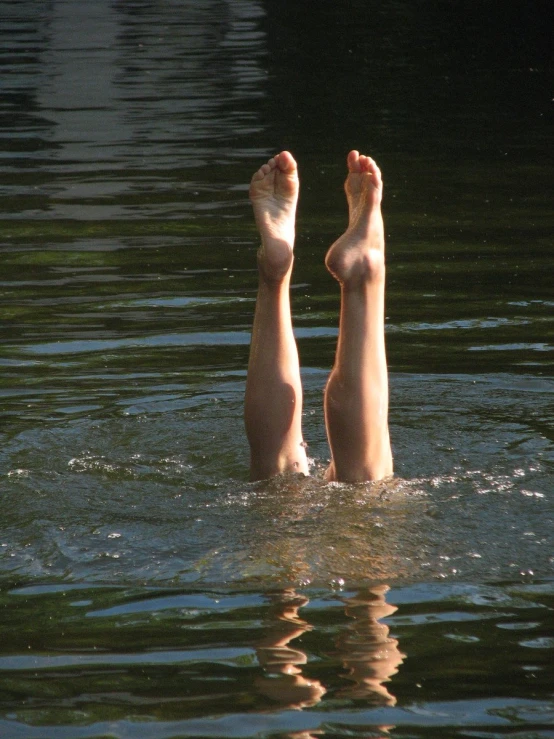 two women are in the water with their feet above the water