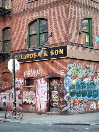 some buildings with graffiti and one bicycle parked